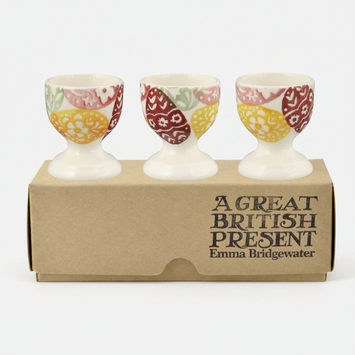 Set of three Emma Bridgewater Easter egg cups with colorful egg designs, displayed in a box, perfect for festive table decor.