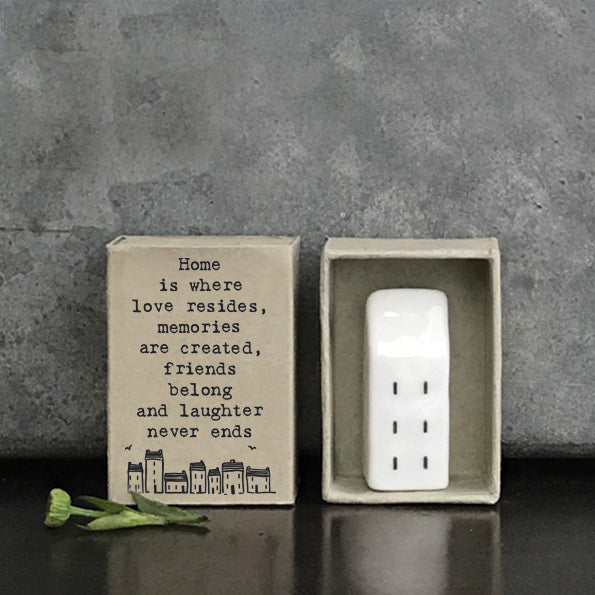 East of India 'Home Is Where the Heart Is' matchbox with vintage-inspired design and soft pastel colors.