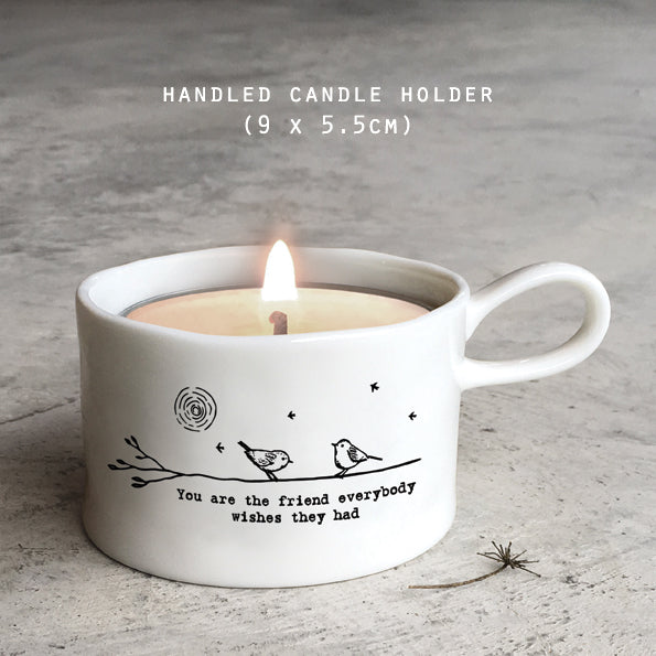 East of India porcelain tea light holder with "You Are the Friend" message, featuring a white hand-painted design and a handle for easy placement.