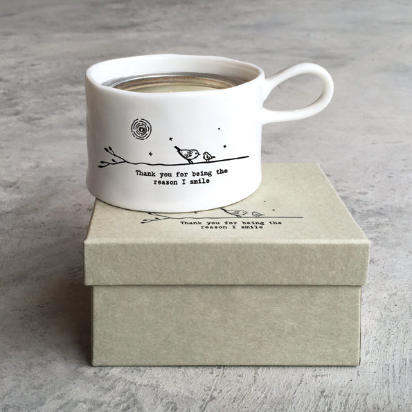 East of India porcelain tea light holder with "You Are the Reason I Smile" inscription, featuring a delicate handle and elegant design.