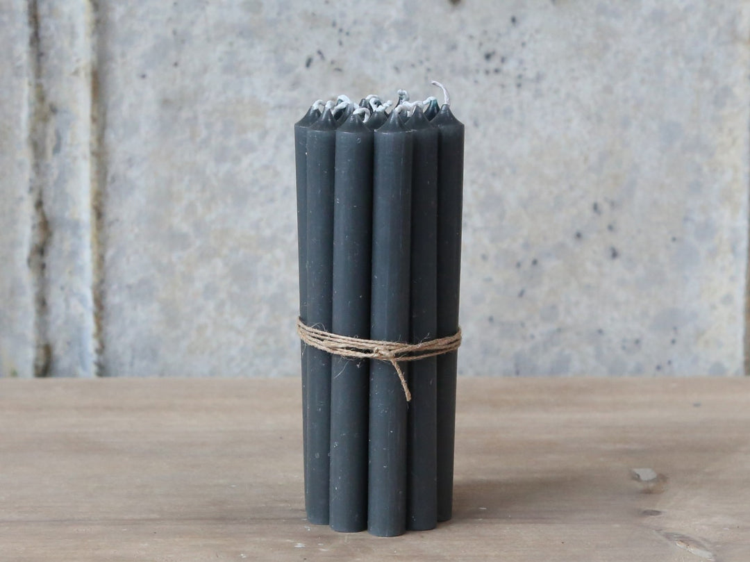 Coal-colored taper candle from Chic Antique by Cornucopia Home and Gift, showing smooth wax surface and classic shape.