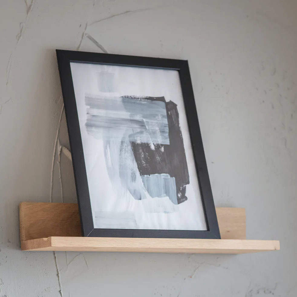 Small Hambledon Picture Shelf by Garden Trading, mounted on a wall with decorative items, showcasing a stylish wooden display shelf.