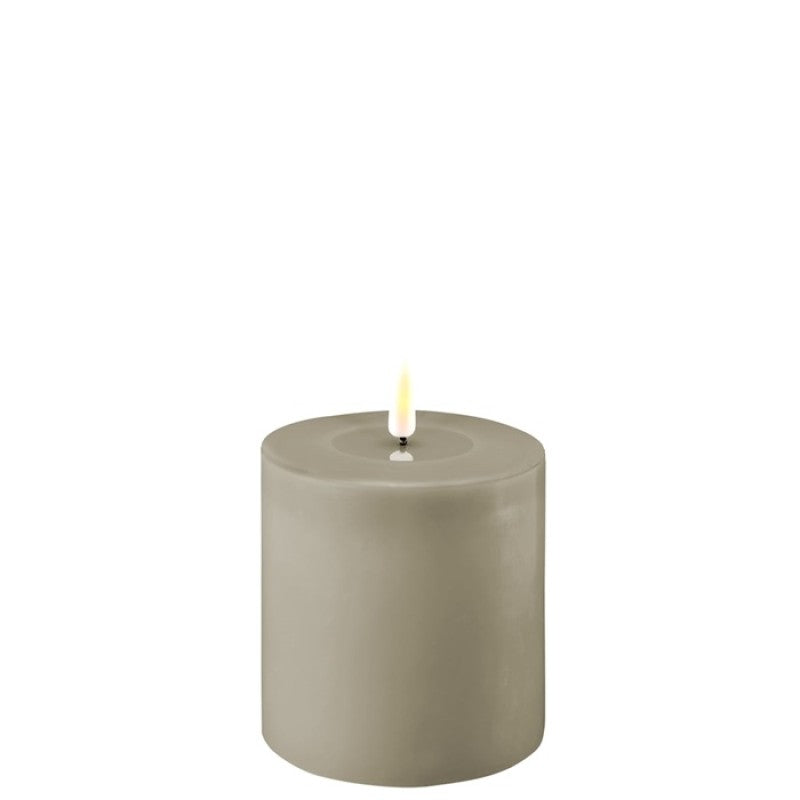 Sand LED candle from Cornucopia Worcester's Deluxe Home Art collection, showcasing a warm, glowing candle with a sand-colored finish.