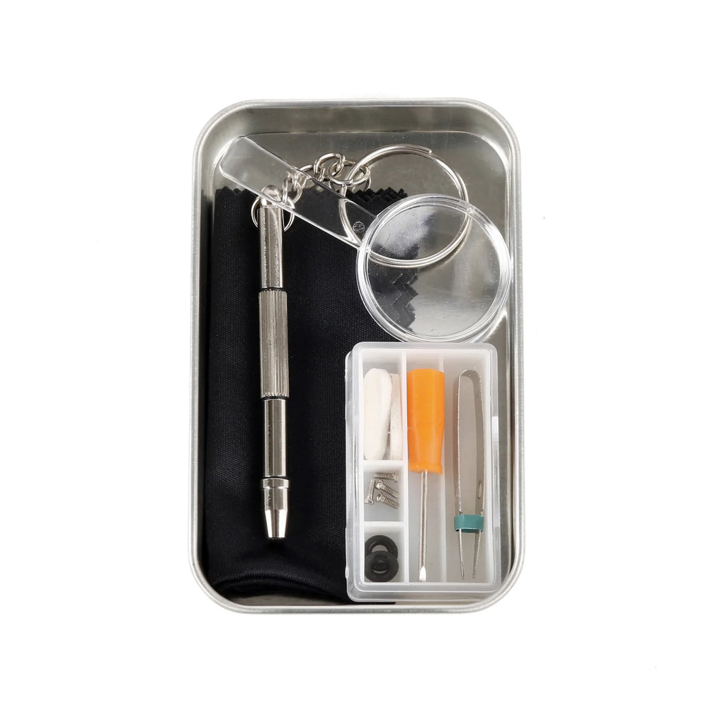 Kikkerland eyeglass repair kit in a compact tin, includes small tools and screws for fixing glasses, ideal for quick repairs