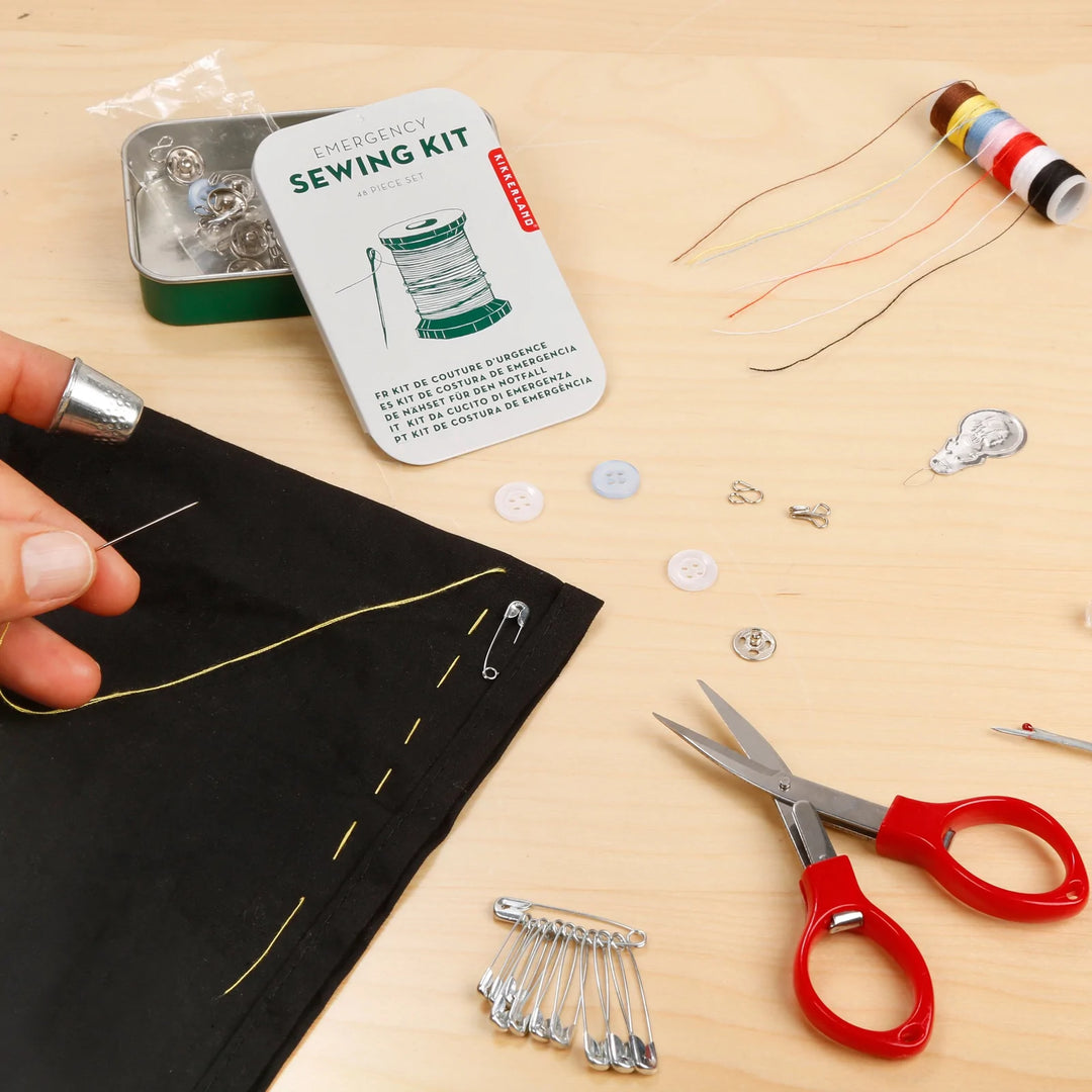 Kikkerland Emergency Sewing Kit in a compact metal tin with sewing needles, thread, and basic sewing tools for quick repairs.