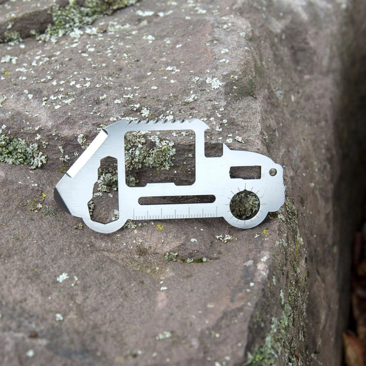 Kikkerland car-shaped survival tool with multiple functions, featuring a compact design and durable metal construction.