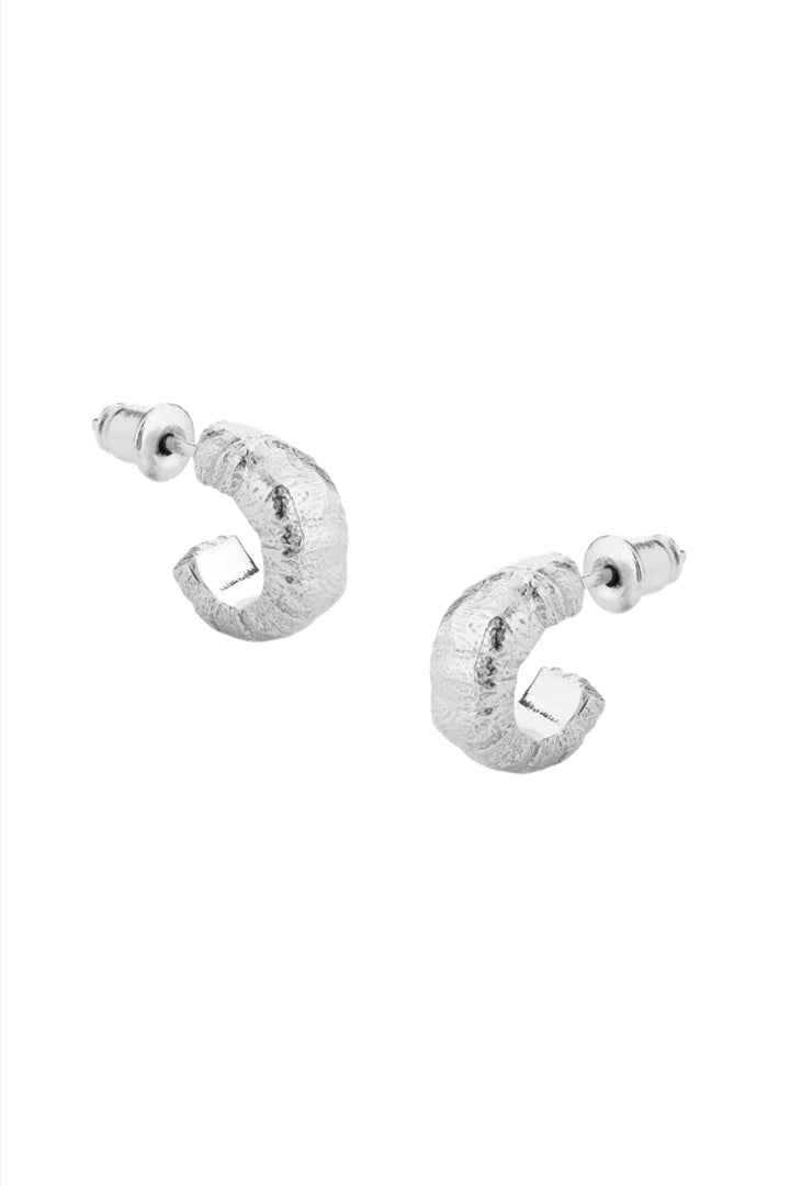 Silver cast earrings by Tutti &amp; Co featuring intricate designs, displayed on a neutral background.