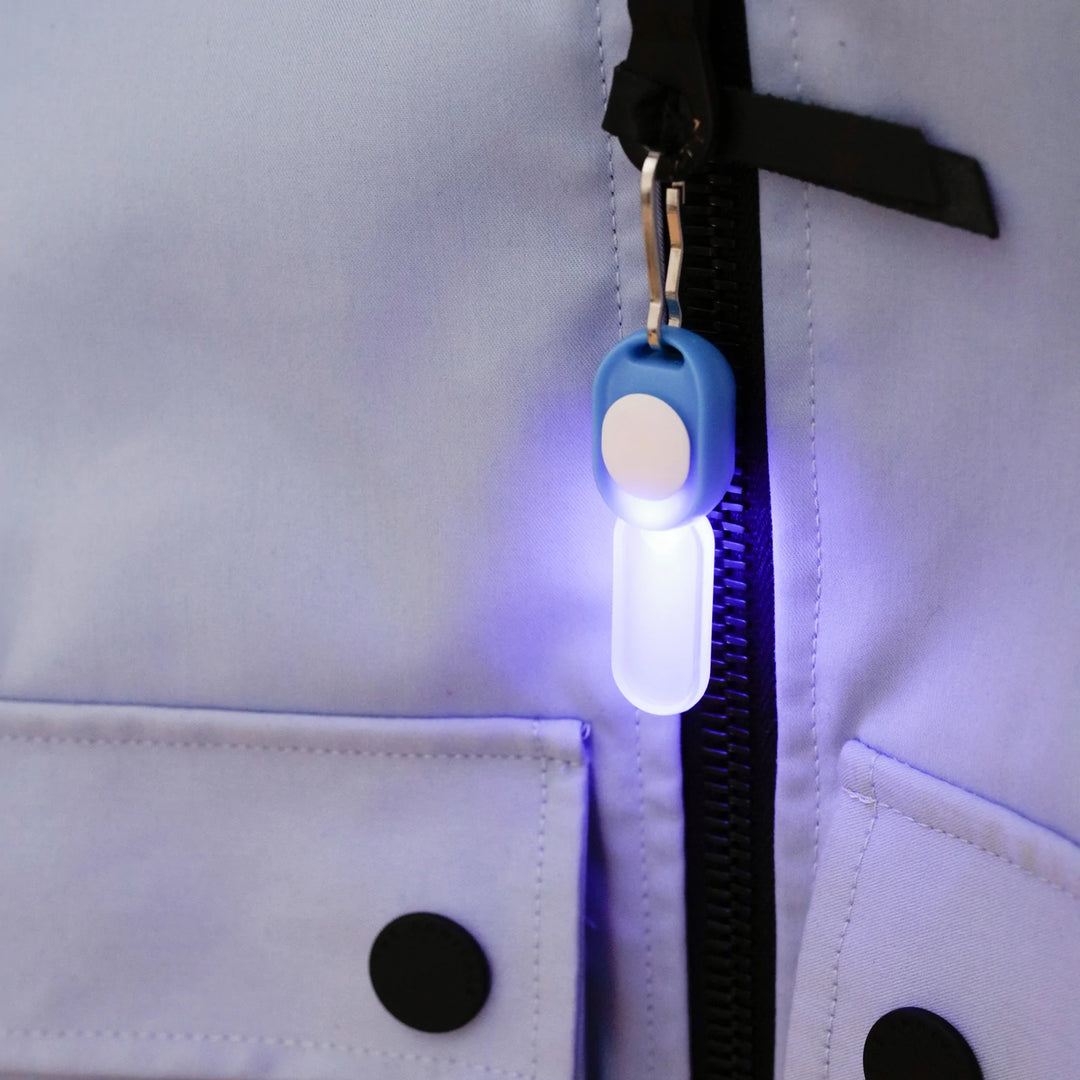 Kikkerland Zipper LED Light in black with zipper design, illuminated with small bright LED bulbs, on a neutral background.