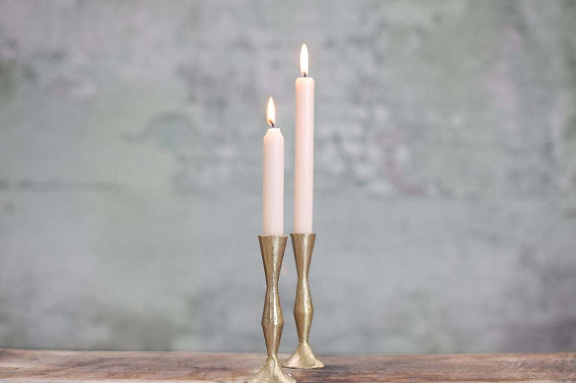 Nkuku Jahi tall brass candlestick with a sleek, modern design, featuring a sturdy base and polished brass finish.