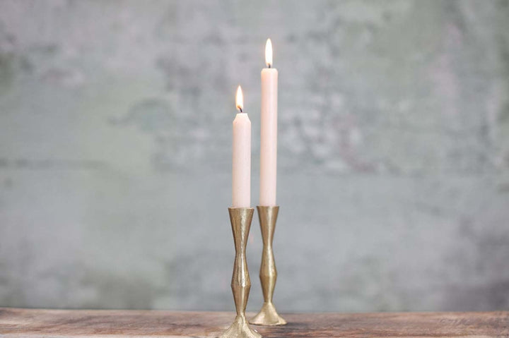 Nkuku Jahi tall brass candlestick with a sleek, modern design, featuring a sturdy base and polished brass finish.