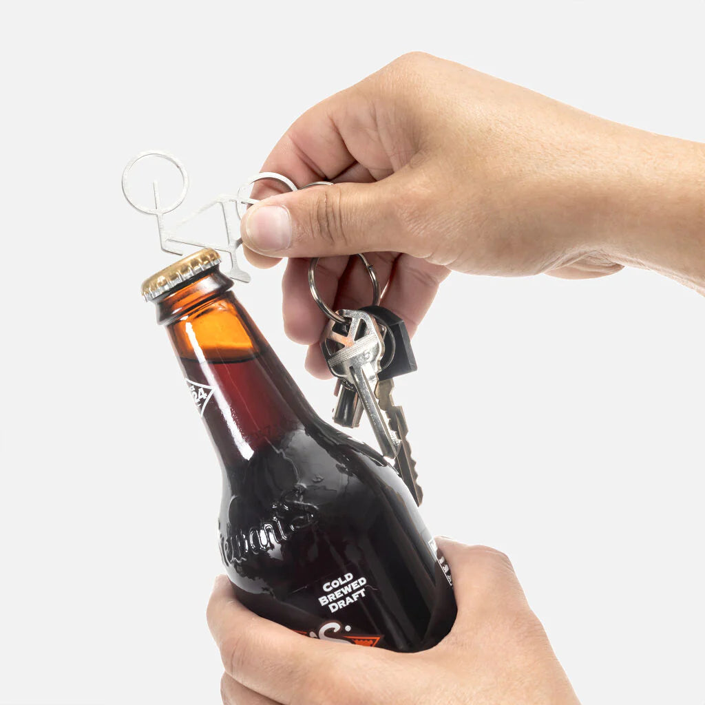 Kikkerland bike-shaped keyring and bottle opener with metal keyring and functional bottle opener, designed for cycling enthusiasts.