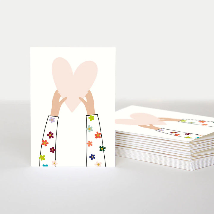 Hands holding up heart blank thank you cards by Caroline Gardner, featuring ten elegant cards with a heart design.