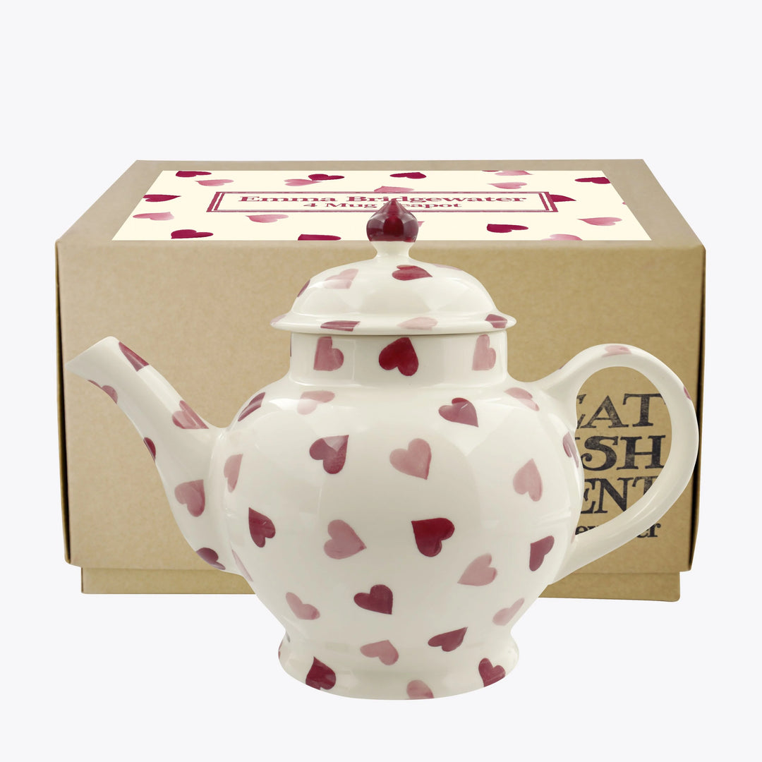 Emma Bridgewater pink hearts teapot with matching mugs, featuring a cheerful pink heart pattern on a white background.