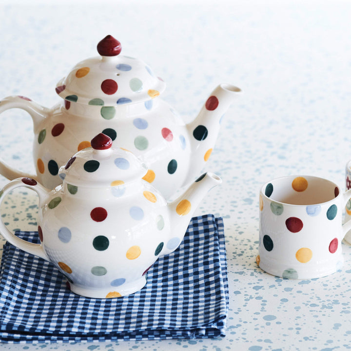 Emma Bridgewater polka dot teapot set with two teapots and small mug, featuring colorful polka dot designs.