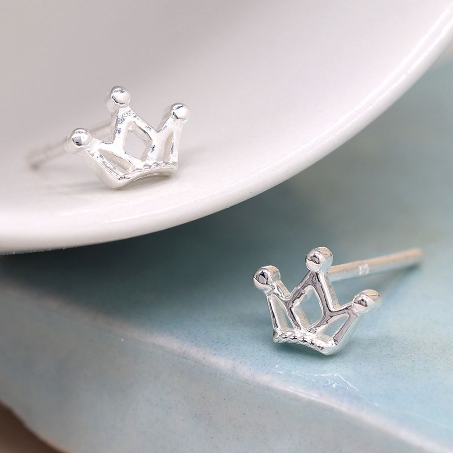 Tiny silver crown stud earrings by POM Jewellery from Cornucopia Worcester, featuring small, detailed crown designs on sterling silver studs.