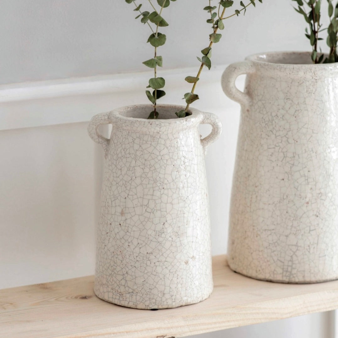 Small Ceramic Ravello Vase by Garden Trading, showcasing its elegant design and smooth finish in a natural setting.