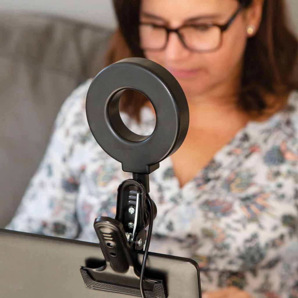 Kikkerland Selfie Ring Light with adjustable brightness, designed for enhanced selfies and video calls, in a sleek circular style.