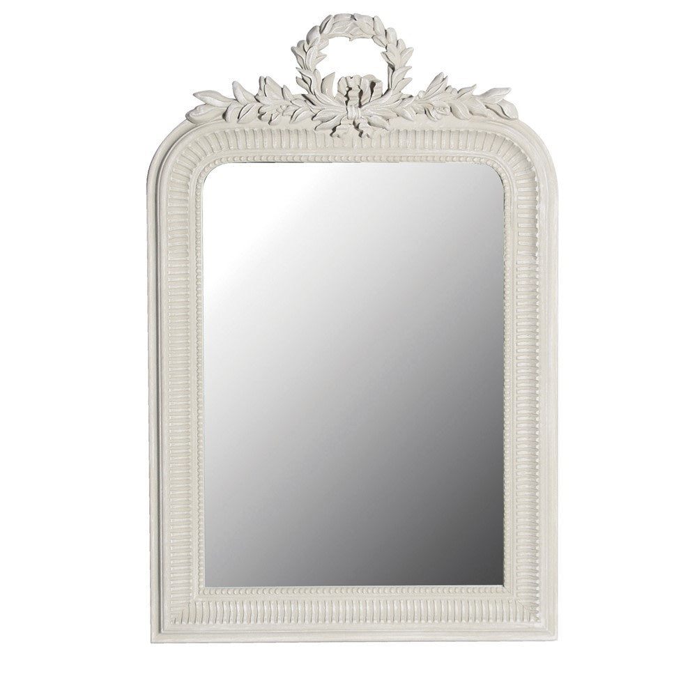 A white, ornate, leaf-patterned wreath mirror.