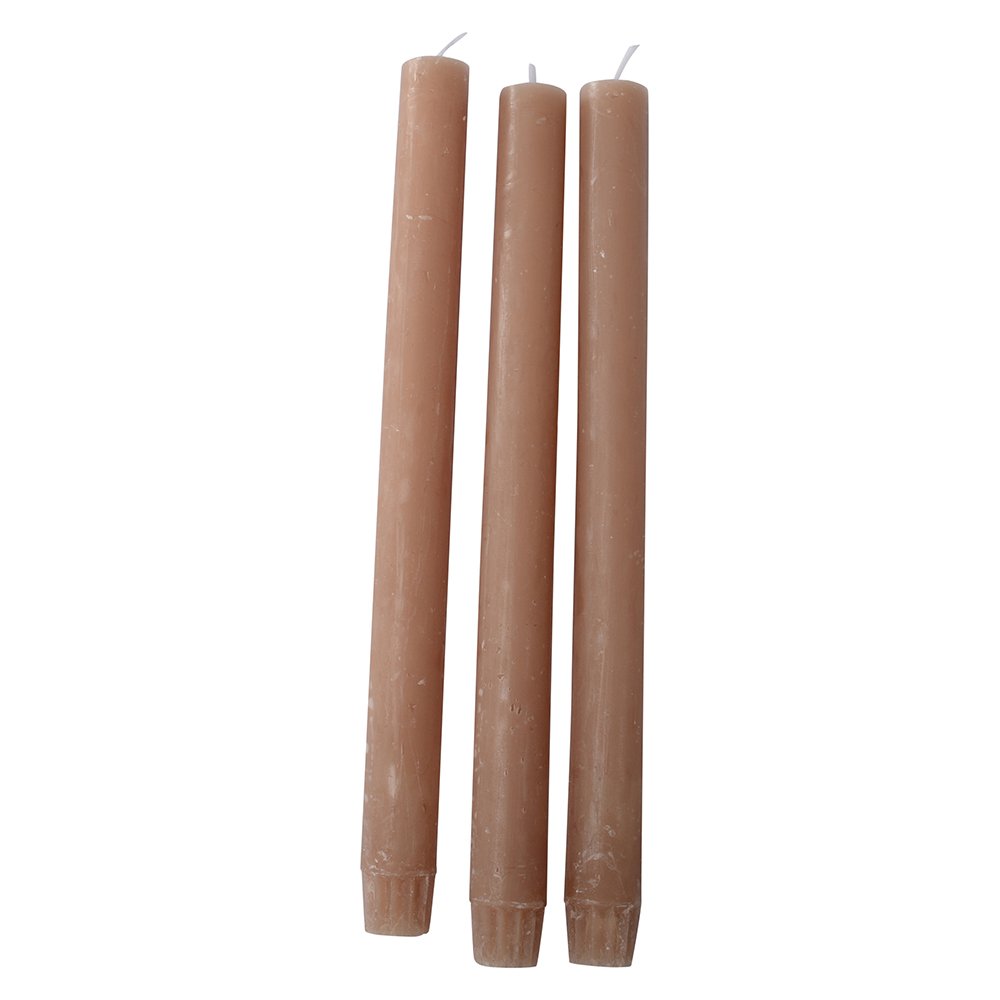 Rustic caramel-colored dinner candle from Grand Illusions by Cornucopia Home and Gift, shown in a natural setting.