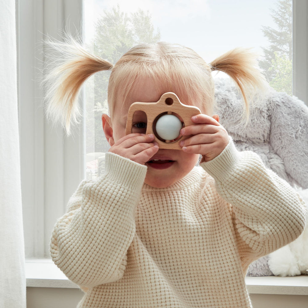 Wooden silicone camera teether by Cornucopia Worcester, featuring a playful camera shape with smooth wooden and silicone elements.