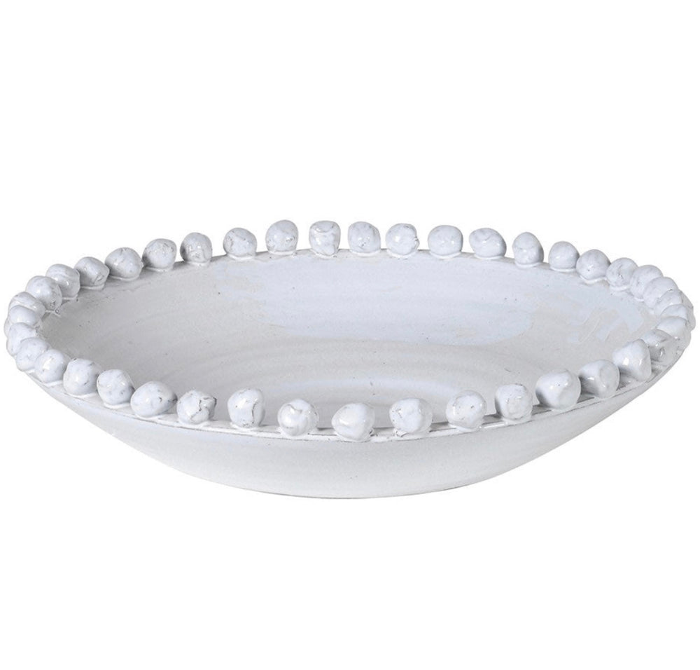 A large white ceramic bowl with a rustic finish and small round bobbles edging the rim.