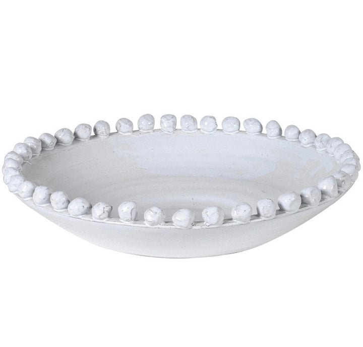 A large white ceramic bowl with a rustic finish and small round bobbles edging the rim.