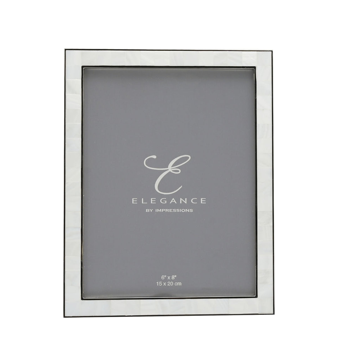 Metal and mother of pearl photo frame by Widdop & Co from Cornucopia Home and Gift, showcasing a decorative frame with intricate details.