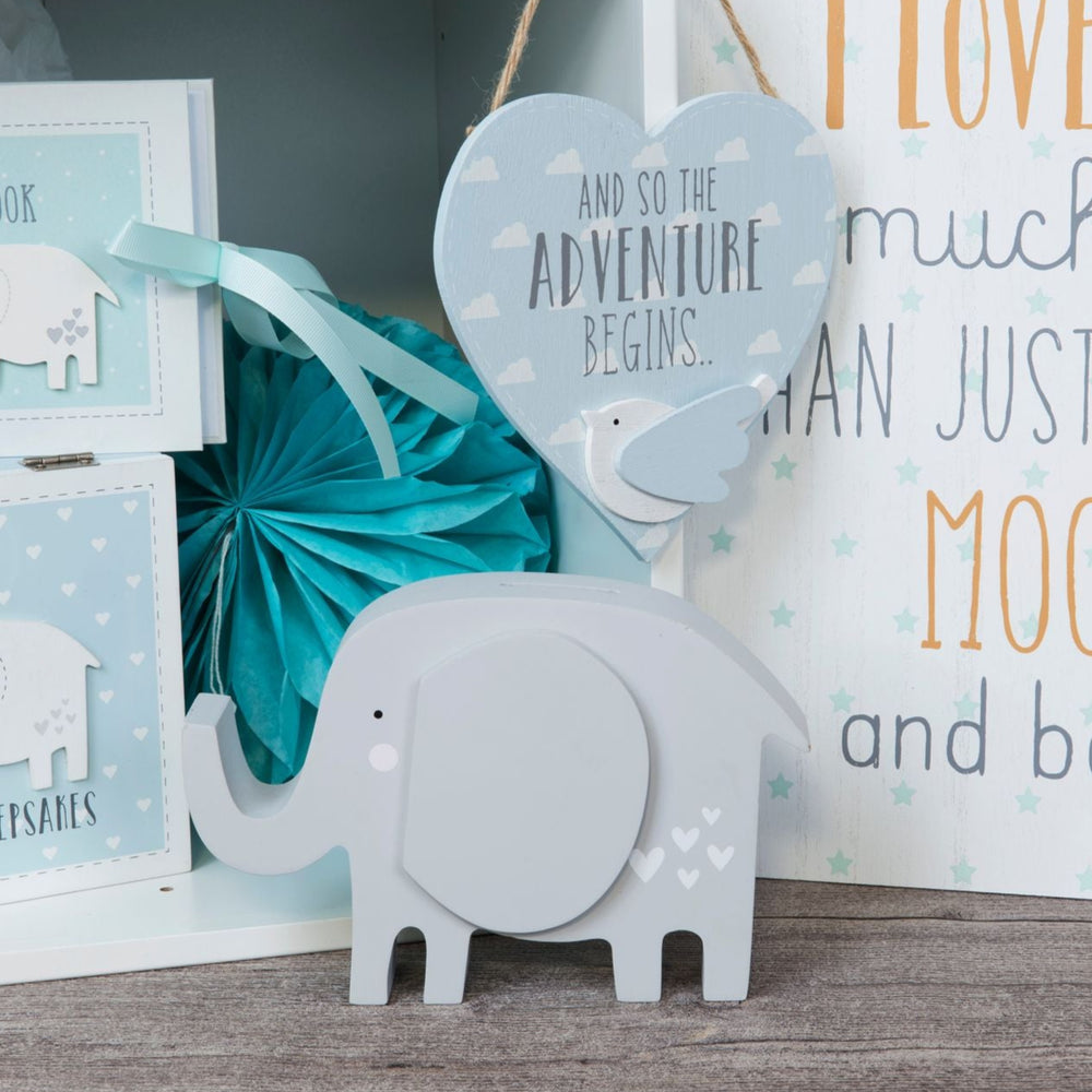 Wooden elephant money box by Cornucopia Home and Gift, featuring a carved elephant design and coin slot on top.