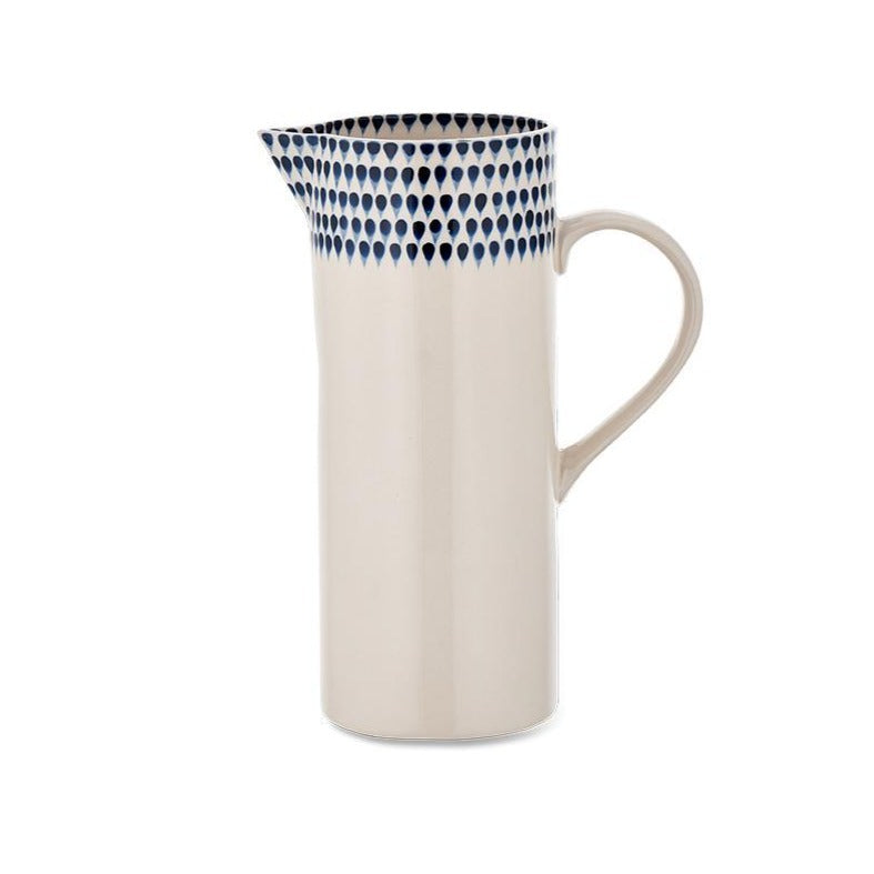 Indigo Drop Jug by Nkuku featuring a ceramic design with a smooth, curved handle and glossy finish on a white background.