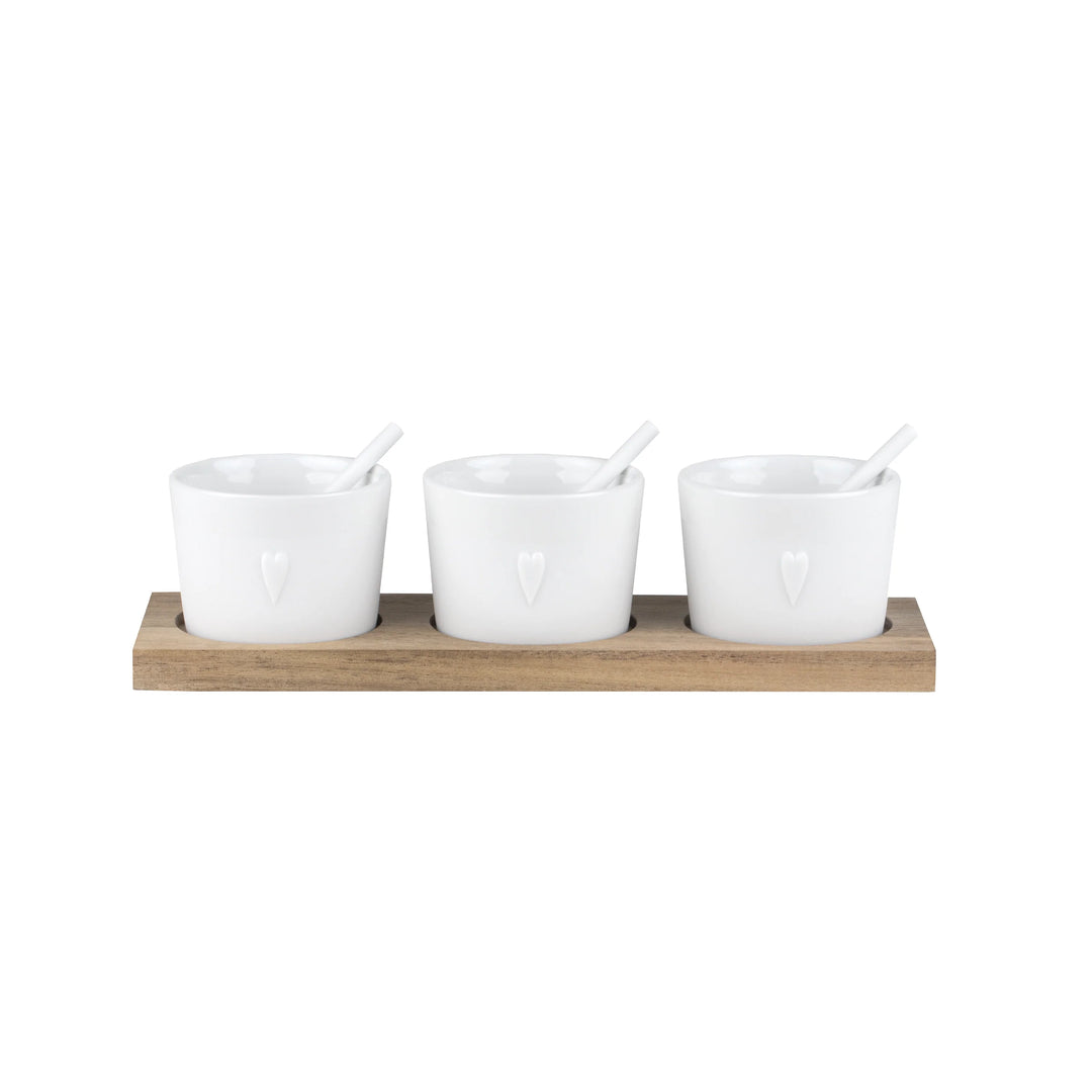 Set of three Radër Heart Embossed Dip Bowls with wooden bases from Cornucopia Home, perfect for serving dips and snacks.