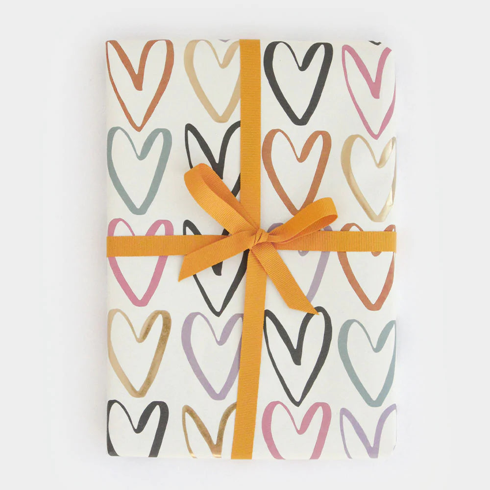 Caroline Gardner rainbow outline hearts wrapping paper with colorful heart designs on a white background.